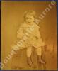 Photographie d'un jeune enfant en robe assis sur une sellette.. --Rare très grand format avec bel envoi autographe signé de Nadar--NADAR (Félix ...
